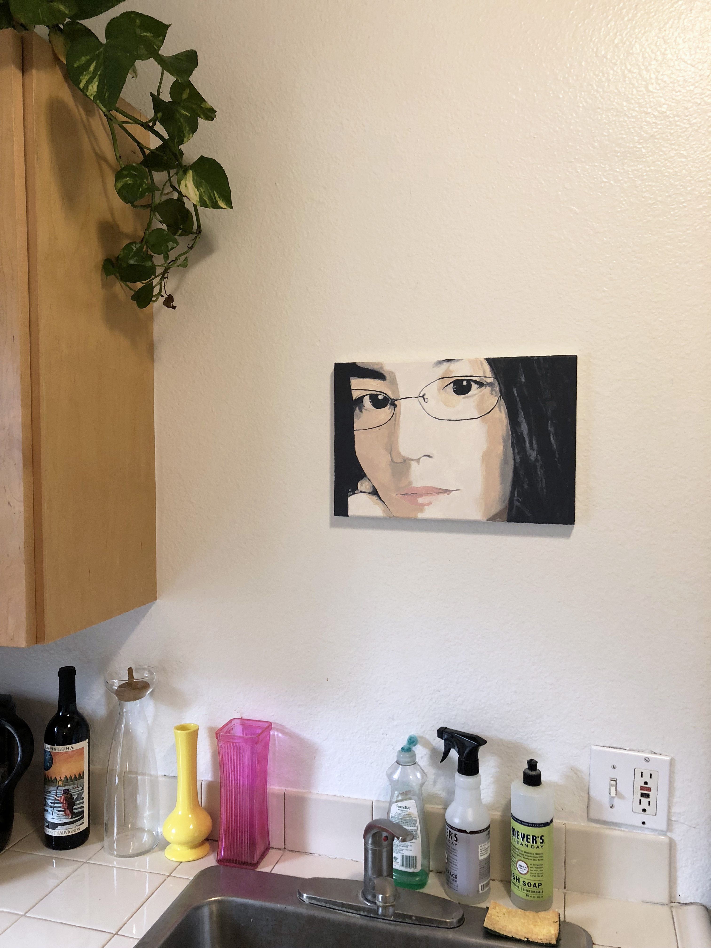 A small painting of Maye Wong, shot from the side above a kitchen sink